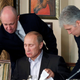 Prigozhin (L) assists Russian Prime Minister Vladimir Putin during a dinner with foreign scholars and journalists in 2011.